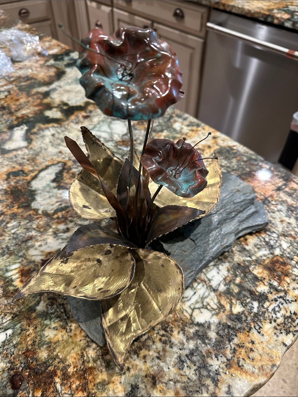These are vintage Brutalist mixed metal floral sculptures mounted on slate bases